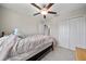 This bedroom features a ceiling fan, a closet with double doors, and neutral walls at 4403 Eternal Prince, Sun City Center, FL 33573