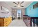 Bright Bedroom featuring a crib, dresser, rocking chair, and colorful decor at 4403 Eternal Prince, Sun City Center, FL 33573