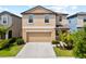 Inviting two-story home showcasing a well-maintained lawn and an attached two-car garage at 4403 Eternal Prince, Sun City Center, FL 33573
