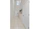 Bright foyer with tile flooring, a staircase, and modern wall art at 4403 Eternal Prince, Sun City Center, FL 33573