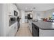 Modern kitchen featuring granite countertops, white cabinetry, and stainless steel appliances at 4403 Eternal Prince, Sun City Center, FL 33573