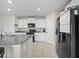 Contemporary kitchen featuring granite countertops, white cabinetry, and stainless steel appliances at 4403 Eternal Prince, Sun City Center, FL 33573