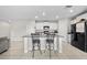 Bright kitchen featuring granite countertops, white cabinetry, and a spacious island with bar seating at 4403 Eternal Prince, Sun City Center, FL 33573