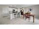 Well-lit kitchen with granite counters, white cabinets, and an adjacent dining area at 4403 Eternal Prince, Sun City Center, FL 33573
