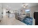 Open-concept living area featuring tile floors and modern, neutral-toned furnishings at 4403 Eternal Prince, Sun City Center, FL 33573