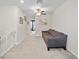 Comfortable loft featuring neutral carpet, a brown sofa, and a safety gate at 4403 Eternal Prince, Sun City Center, FL 33573