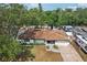 Aerial view of a single story house with a brown roof, green lawns, and an RV in the driveway at 4609 S Lois Ave, Tampa, FL 33611