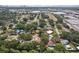 Wide aerial view showcasing a residential area with houses, trees, and glimpses of the city and waterfront at 4609 S Lois Ave, Tampa, FL 33611