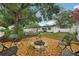 Inviting backyard with stone fire pit and ample seating, perfect for outdoor relaxation and entertainment at 4609 S Lois Ave, Tampa, FL 33611