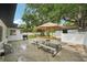 A spacious backyard patio with a picnic table, grill, and games is perfect for outdoor entertaining at 4609 S Lois Ave, Tampa, FL 33611