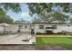 A beautiful backyard with a patio, putting green, swing, and lovely plantings is ready to host your outdoor living at 4609 S Lois Ave, Tampa, FL 33611