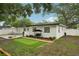 A well-maintained backyard features a patio, putting green, and a shaded swing at 4609 S Lois Ave, Tampa, FL 33611