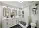 Modern bathroom featuring double vanity, a glass-enclosed shower, and black and white tile at 4609 S Lois Ave, Tampa, FL 33611