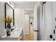 Bathroom view into the home, featuring modern fixtures, and stylish finishes with a partial view of a mirror at 4609 S Lois Ave, Tampa, FL 33611