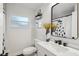 Stylish bathroom with a large mirror, modern sink, and decorative elements offering a fresh and inviting atmosphere at 4609 S Lois Ave, Tampa, FL 33611