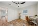 Bedroom features wood-look floors, a modern ceiling fan, and a desk area, creating a versatile and stylish space at 4609 S Lois Ave, Tampa, FL 33611