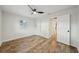 Bright bedroom featuring wood-look floors, a modern ceiling fan, and closet with sliding doors at 4609 S Lois Ave, Tampa, FL 33611