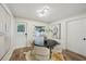 Cozy dining room with a round table, four chairs, and a minimalist art piece on the wall at 4609 S Lois Ave, Tampa, FL 33611