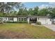 Charming single-story home with a well-maintained front lawn and classic exterior at 4609 S Lois Ave, Tampa, FL 33611