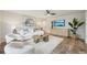Cozy living room featuring white furniture, a modern ceiling fan, and decorative artwork at 4609 S Lois Ave, Tampa, FL 33611