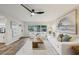 Comfortable living area with white seating, wood-look flooring, and ample natural light at 4609 S Lois Ave, Tampa, FL 33611