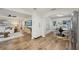 Open-concept living and dining area featuring hardwood floors, white walls, and modern furnishings at 4609 S Lois Ave, Tampa, FL 33611