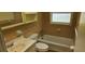 Retro bathroom features a tub, toilet, and vanity with coordinated tile and fixtures at 4754 17Th St, Zephyrhills, FL 33542