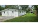 Rear view of home, featuring backyard access and ample parking space at 4754 17Th St, Zephyrhills, FL 33542