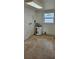 Functional utility room features a water heater and natural light from the window at 4754 17Th St, Zephyrhills, FL 33542