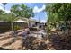 Enjoy this backyard featuring a brick patio with a swing and umbrella for outdoor relaxation at 502 Dewolf Rd, Brandon, FL 33511