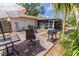 Outdoor patio with a grill, table, and seating, offering a perfect space for entertaining at 502 Dewolf Rd, Brandon, FL 33511