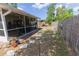 Spacious backyard with a screened-in lanai, walkway, and a fenced perimeter at 502 Dewolf Rd, Brandon, FL 33511