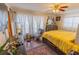 Bright bedroom featuring a bed, a ceiling fan, and large windows with decorative curtains at 502 Dewolf Rd, Brandon, FL 33511