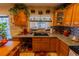 Classic kitchen featuring custom wood cabinetry, granite countertops, and tiled backsplash at 502 Dewolf Rd, Brandon, FL 33511