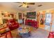 Spacious living room with red leather furniture, a TV, and a decorative fireplace at 502 Dewolf Rd, Brandon, FL 33511