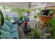 Cozy covered patio with comfortable seating, a ceiling fan, and lush greenery at 502 Dewolf Rd, Brandon, FL 33511