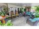 Covered patio with a ceiling fan, various plants, and comfortable seating area at 502 Dewolf Rd, Brandon, FL 33511