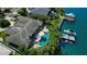 An aerial view of a property featuring a pool, spa, and a boat dock on the water at 511 Island Way, Clearwater Beach, FL 33767