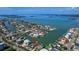 Stunning aerial view showcases the waterfront property with a pool, boat dock, and coastal neighborhood at 511 Island Way, Clearwater Beach, FL 33767