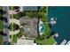 Overhead view of the landscaped property featuring a dock, pool, patio, and a well-maintained roof at 511 Island Way, Clearwater Beach, FL 33767