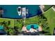 Aerial view of property featuring a boat dock, lush lawn, and swimming pool with spa at 511 Island Way, Clearwater Beach, FL 33767