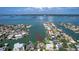 Aerial view of waterfront homes with boat docks and pool at 511 Island Way, Clearwater Beach, FL 33767