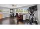 Bedroom features an exercise machine, dark laminate floors, and a ceiling fan at 511 Island Way, Clearwater Beach, FL 33767