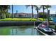 Waterfront home featuring a private dock, lush lawn, and ample outdoor space for relaxation and enjoyment at 511 Island Way, Clearwater Beach, FL 33767
