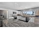 Modern white kitchen with stainless steel appliances, granite countertops, and a large window with water views at 511 Island Way, Clearwater Beach, FL 33767