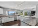 Bright kitchen features granite countertops, stainless appliances, and scenic waterfront views at 511 Island Way, Clearwater Beach, FL 33767