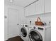 Laundry room featuring a washer, dryer and upper cabinets at 511 Island Way, Clearwater Beach, FL 33767
