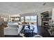 Open-concept living room with fireplace, hardwood floors and waterfront view at 511 Island Way, Clearwater Beach, FL 33767