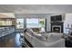 Spacious living room with water views, fireplace, and access to the pool and patio at 511 Island Way, Clearwater Beach, FL 33767
