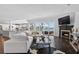 Bright living room features a fireplace, large sectional, and sliding glass doors with waterfront views at 511 Island Way, Clearwater Beach, FL 33767